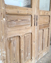Wooden door with glass panels on a wooden floor