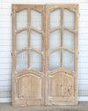 Pair of wooden doors with glass panels on a white background